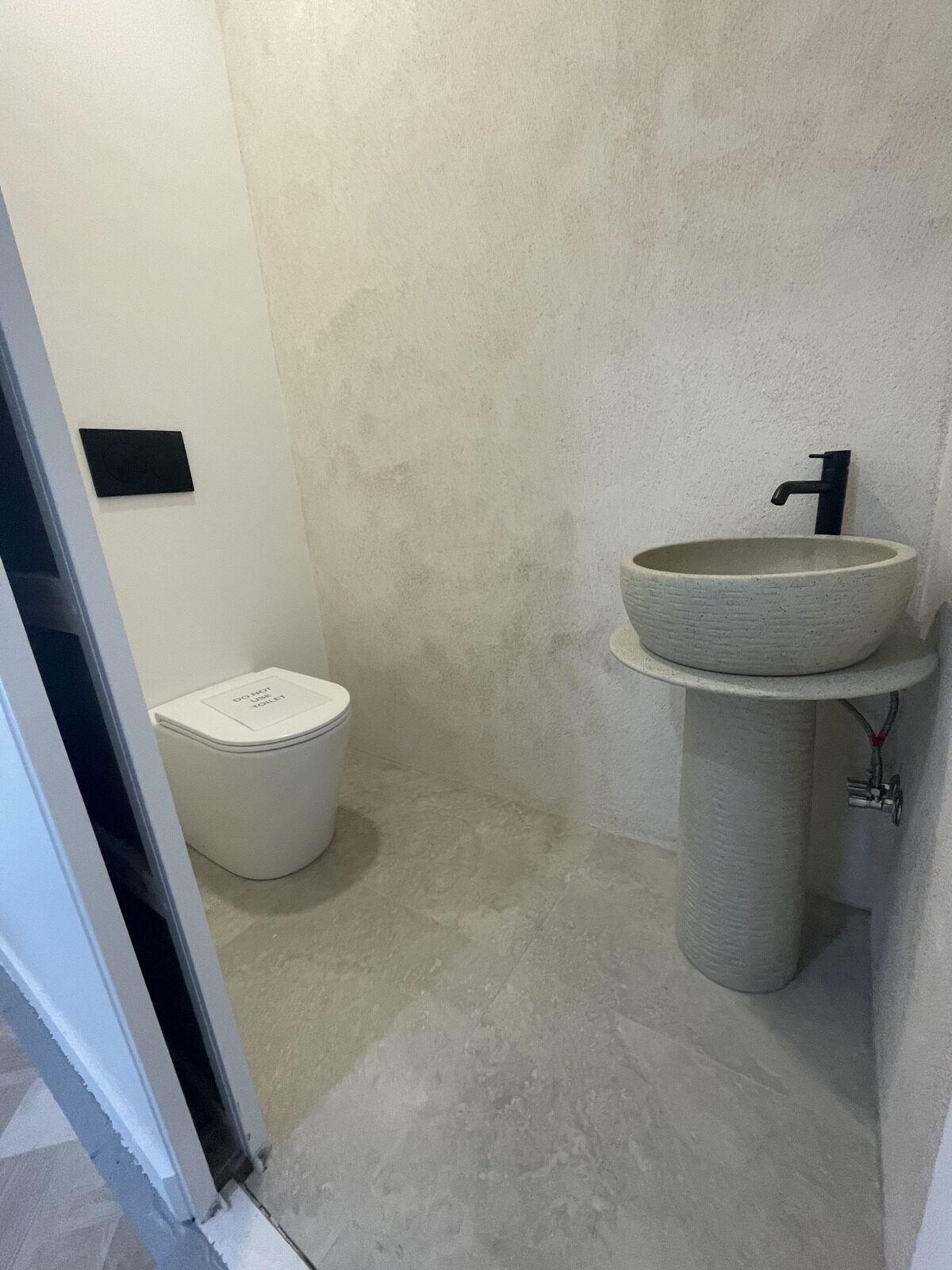 Microcement powder room walls and floor