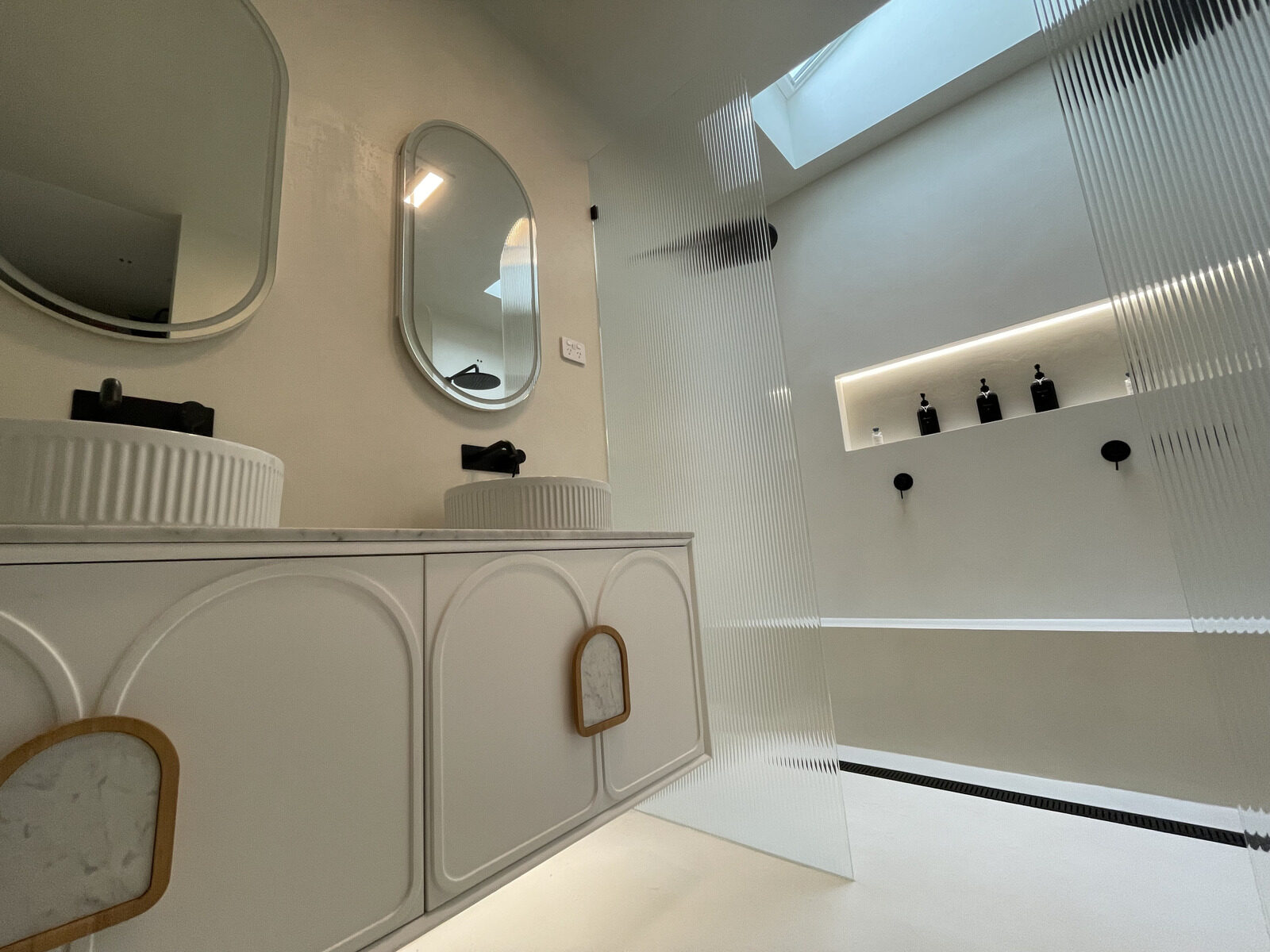 Microcement bathroom with seamless floor and vanity